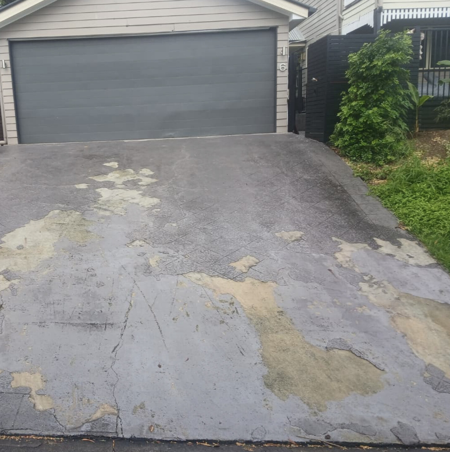 Worn, patchy concrete driveway before resurfacing