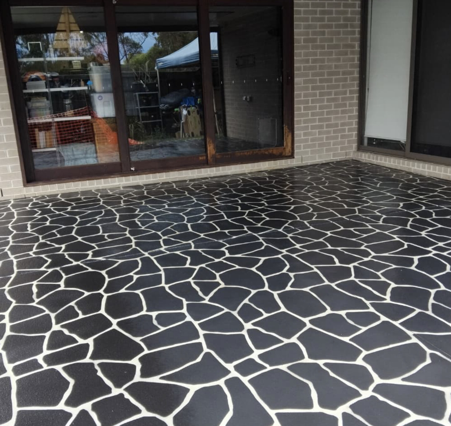 Charcoal crazy-pave stencil finish patio after resurfacing