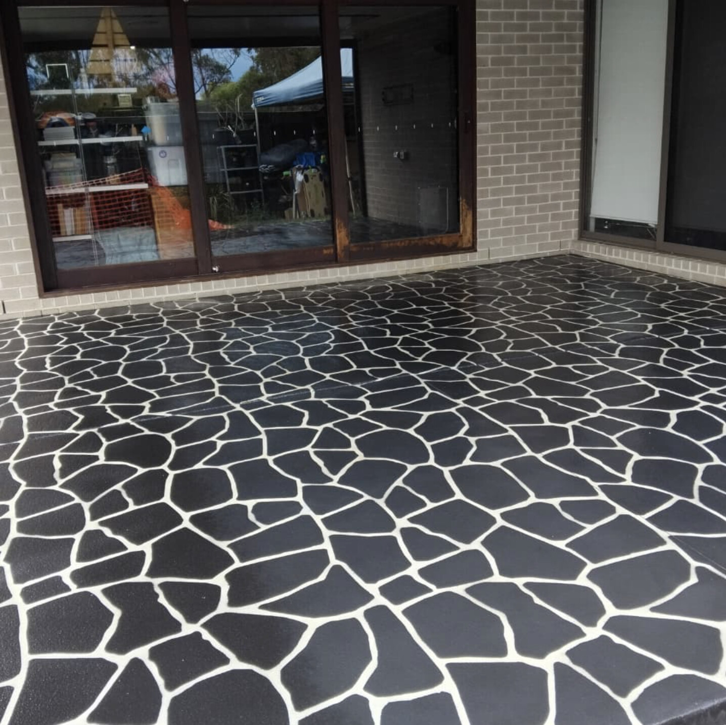 Charcoal crazy-pave stencil alfresco area after resurfacing