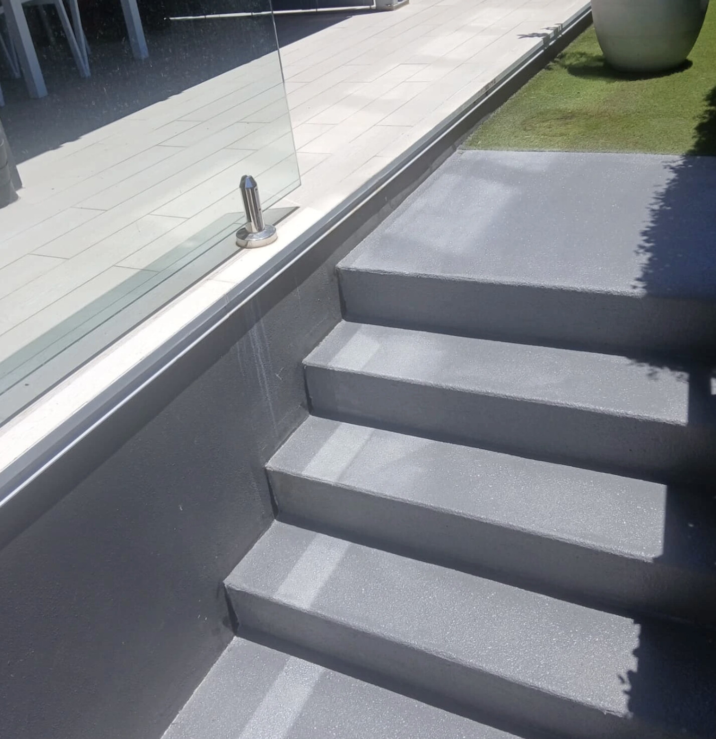 Sleek dark grey resurfaced entry steps