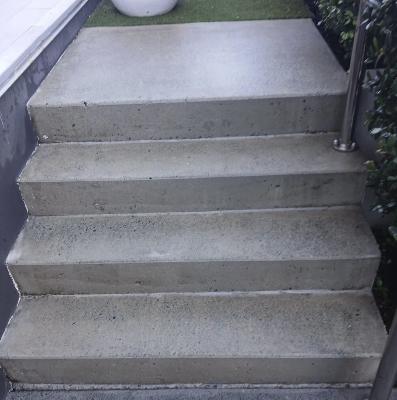 Worn porous concrete entry steps before resurfacing
