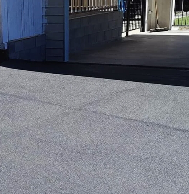 Grey fleck spray-on driveway after resurfacing